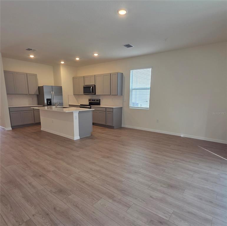 3258 Chroma Street Orlando, FL 32824 - Photo 2 of 3 a view of kitchen with wooden floor and electronic appliances
