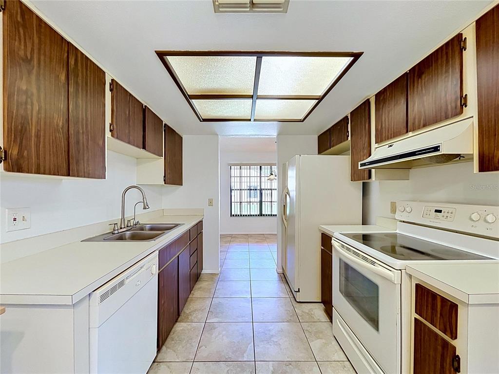 9319 Trowbridge Court New Port Richey, FL 34655 - Photo 30 of 78 a kitchen with a sink stove and cabinets