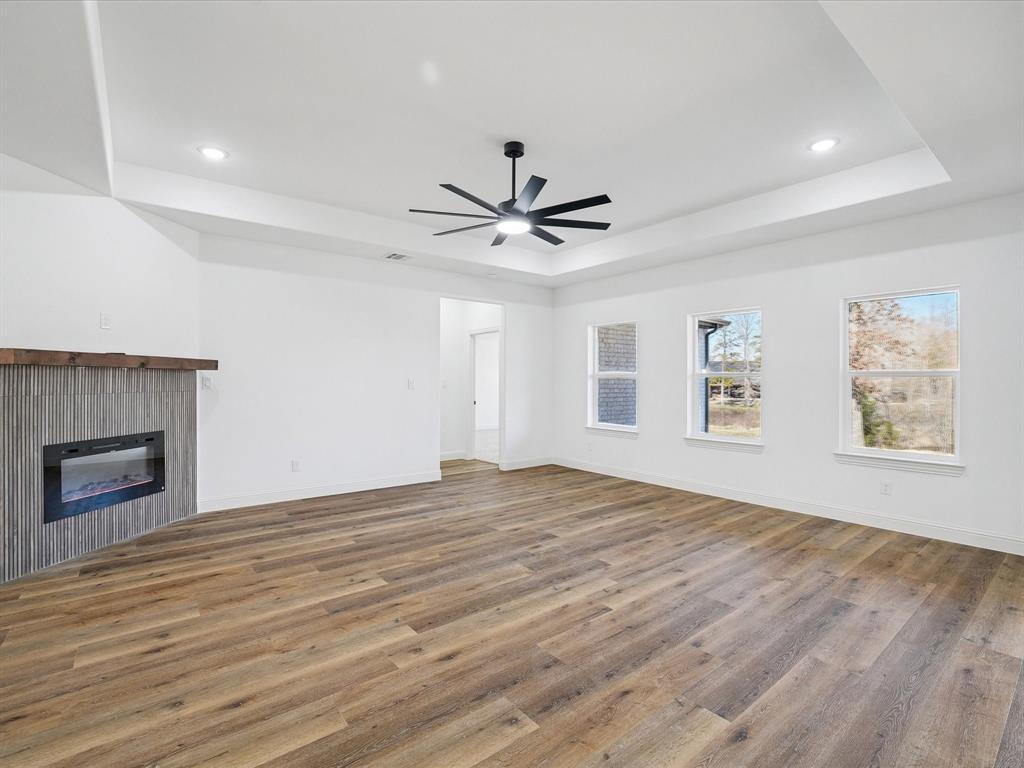 448 Rs County Road Alba, TX 75410 - Photo 14 of 34 an empty room with wooden floor and a ceiling fan