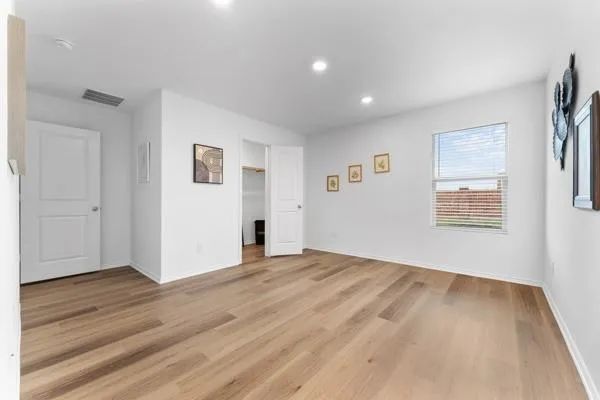 a kitchen with a sink and wooden floor