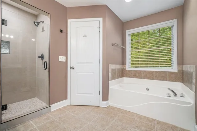 a bathroom with a bathtub and shower