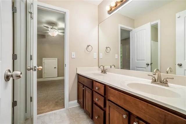 a bathroom with a double vanity sink mirror and shower