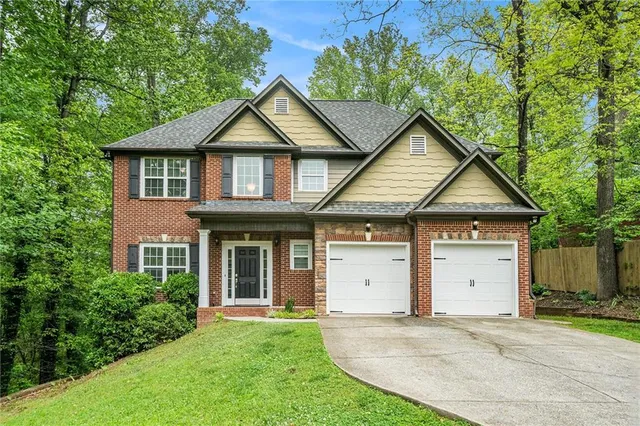 a house with green field in front of it