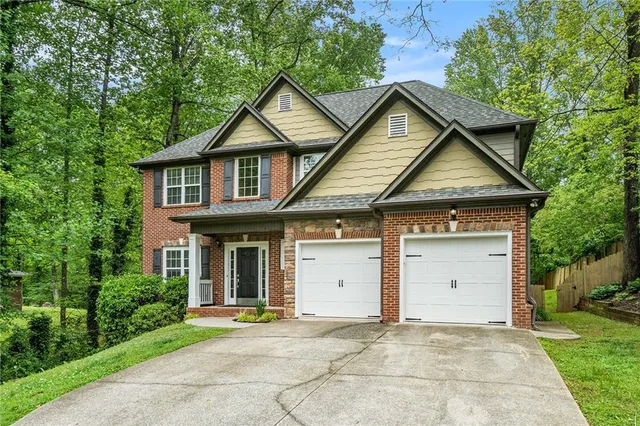 a front view of a house with a yard and garage