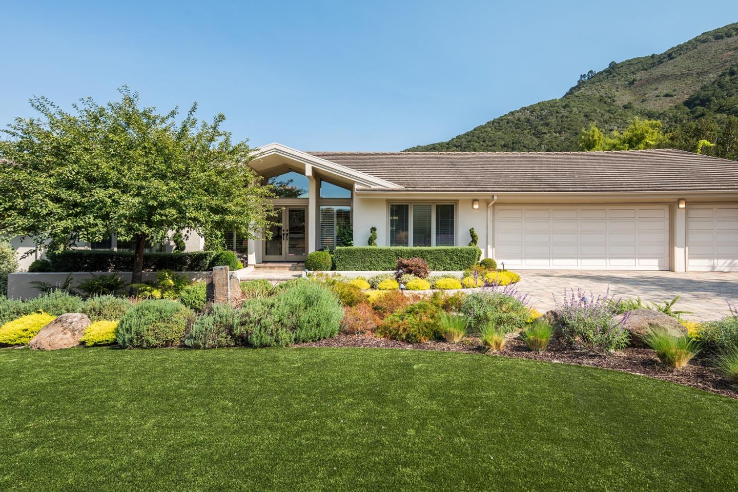a front view of a house with garden