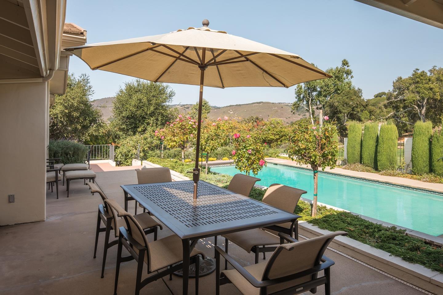 9975 Holt Road Carmel, CA 93923 - Photo 3 of 10 a view of a roof deck with table and chairs under an umbrella