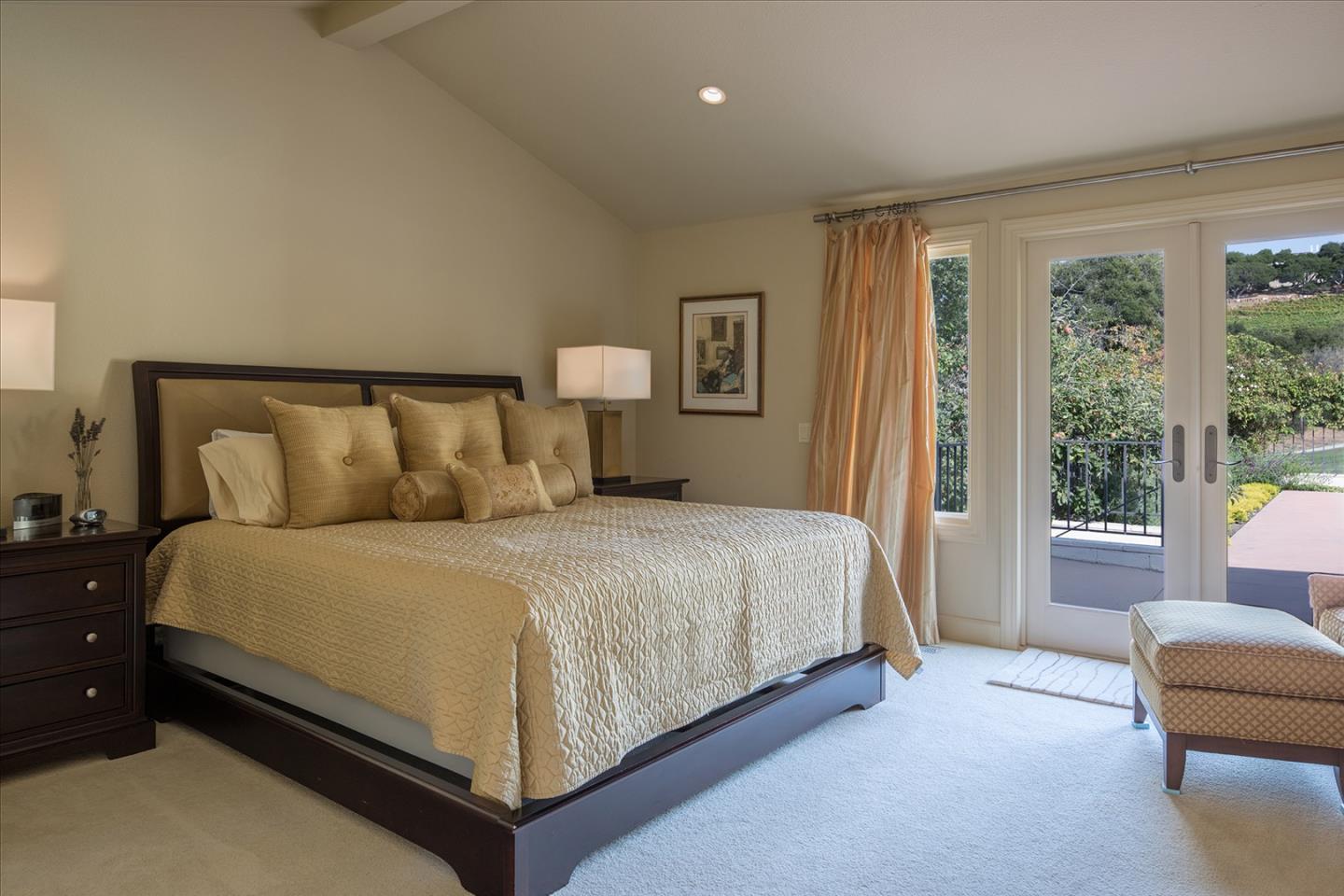 9975 Holt Road Carmel, CA 93923 - Photo 6 of 10 a large bed sitting in a bedroom next to a window
