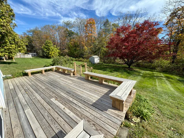 a view of a wooden deck with a yard