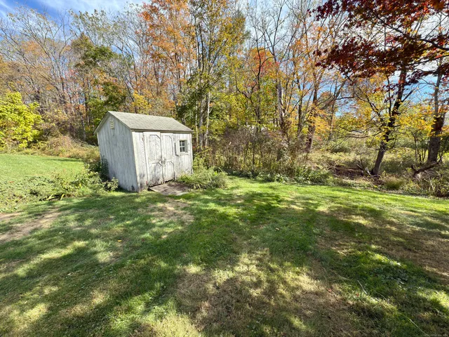 a view of a big yard with large trees