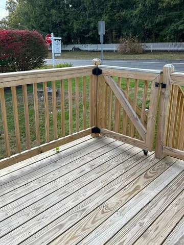 a view of balcony with wooden floor and fence