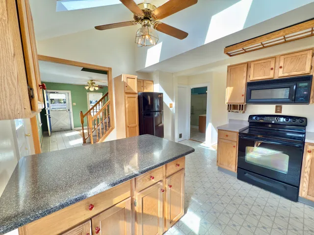 a kitchen with stainless steel appliances granite countertop a sink and a stove