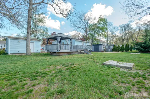 a view of a house with a yard and sitting area