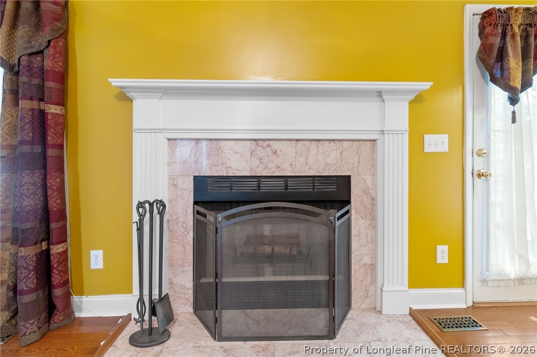 8017 Trout Creek Road Fayetteville, NC 28304 - Photo 11 of 38 a living room with a fireplace and a rug