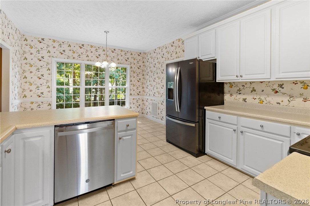 8017 Trout Creek Road Fayetteville, NC 28304 - Photo 13 of 38 a kitchen with stainless steel appliances a refrigerator sink and cabinets