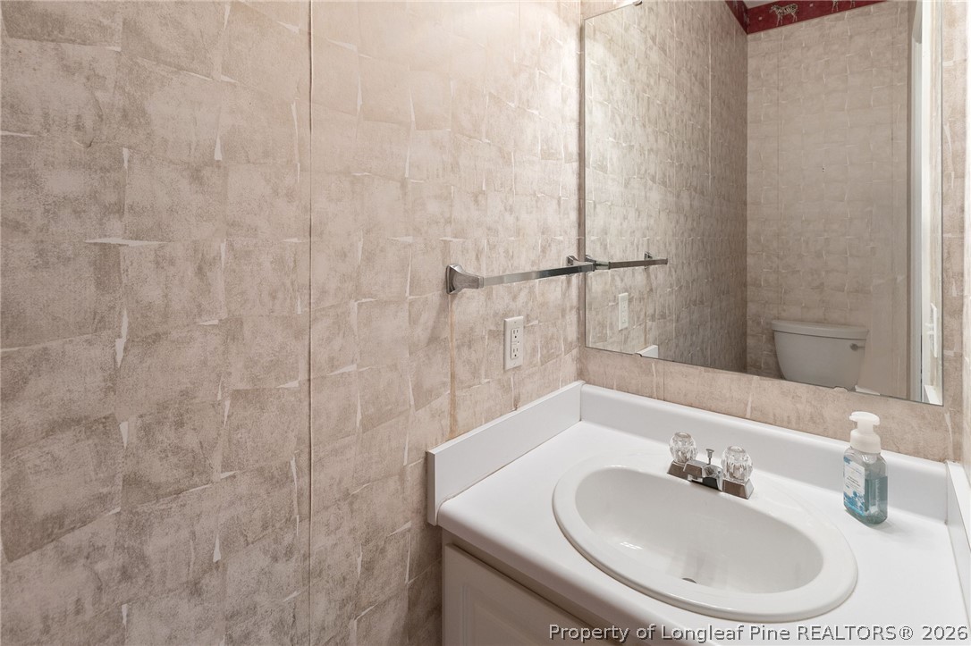 8017 Trout Creek Road Fayetteville, NC 28304 - Photo 18 of 38 a bathroom with a sink and a mirror