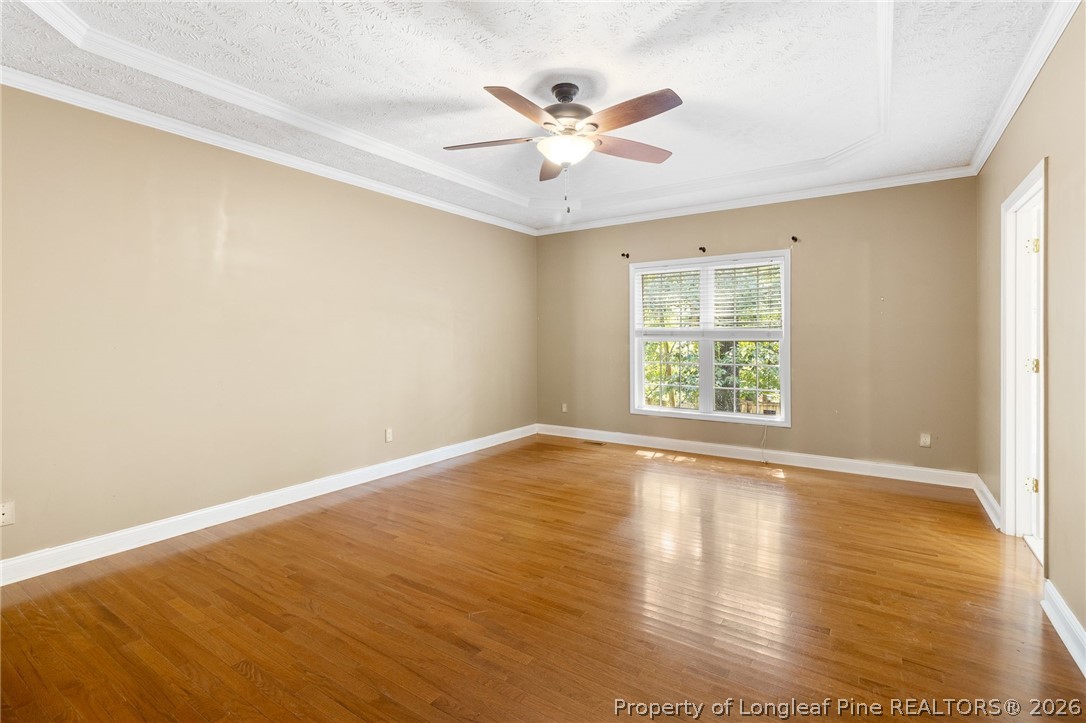 8017 Trout Creek Road Fayetteville, NC 28304 - Photo 19 of 38 an view of an empty room with wooden floor and a window