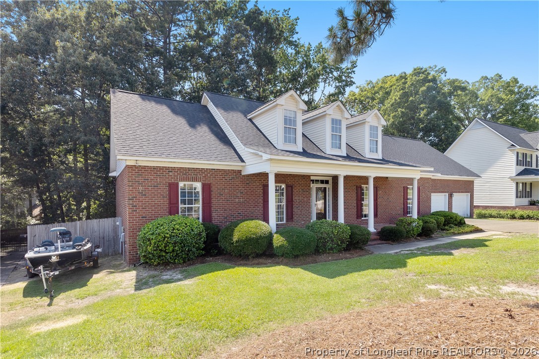 8017 Trout Creek Road Fayetteville, NC 28304 - Photo 2 of 38 a front view of a house with garden and trees