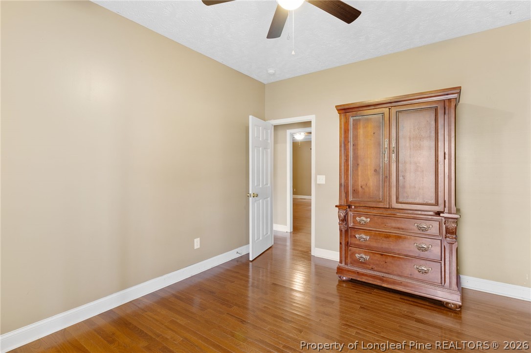 8017 Trout Creek Road Fayetteville, NC 28304 - Photo 22 of 38 an empty room with wooden floor closet and windows
