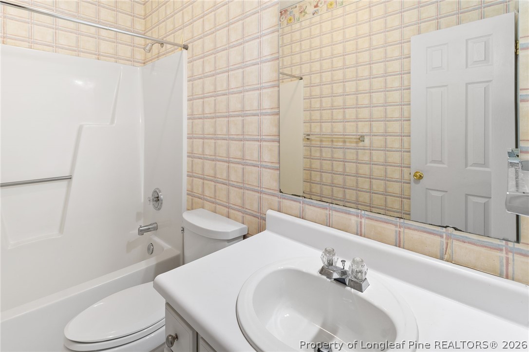 8017 Trout Creek Road Fayetteville, NC 28304 - Photo 23 of 38 a bathroom with a sink toilet and shower