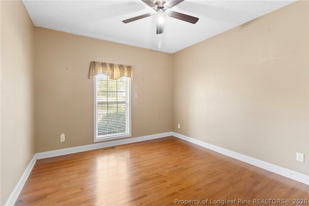 8017 Trout Creek Road Fayetteville, NC 28304 - Photo 24 of 38 wooden floor in an empty room with a window