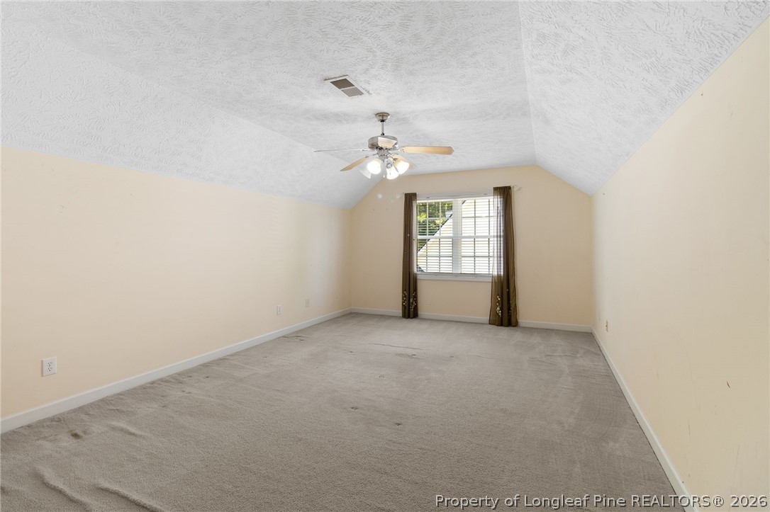 8017 Trout Creek Road Fayetteville, NC 28304 - Photo 26 of 38 an empty room with windows and ceiling fan
