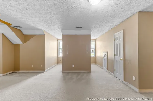 a view of a hallway with wooden shelves