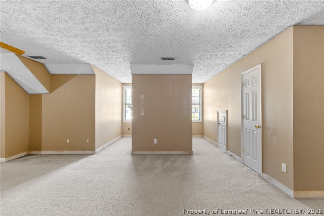 8017 Trout Creek Road Fayetteville, NC 28304 - Photo 29 of 38 a view of a hallway with wooden shelves