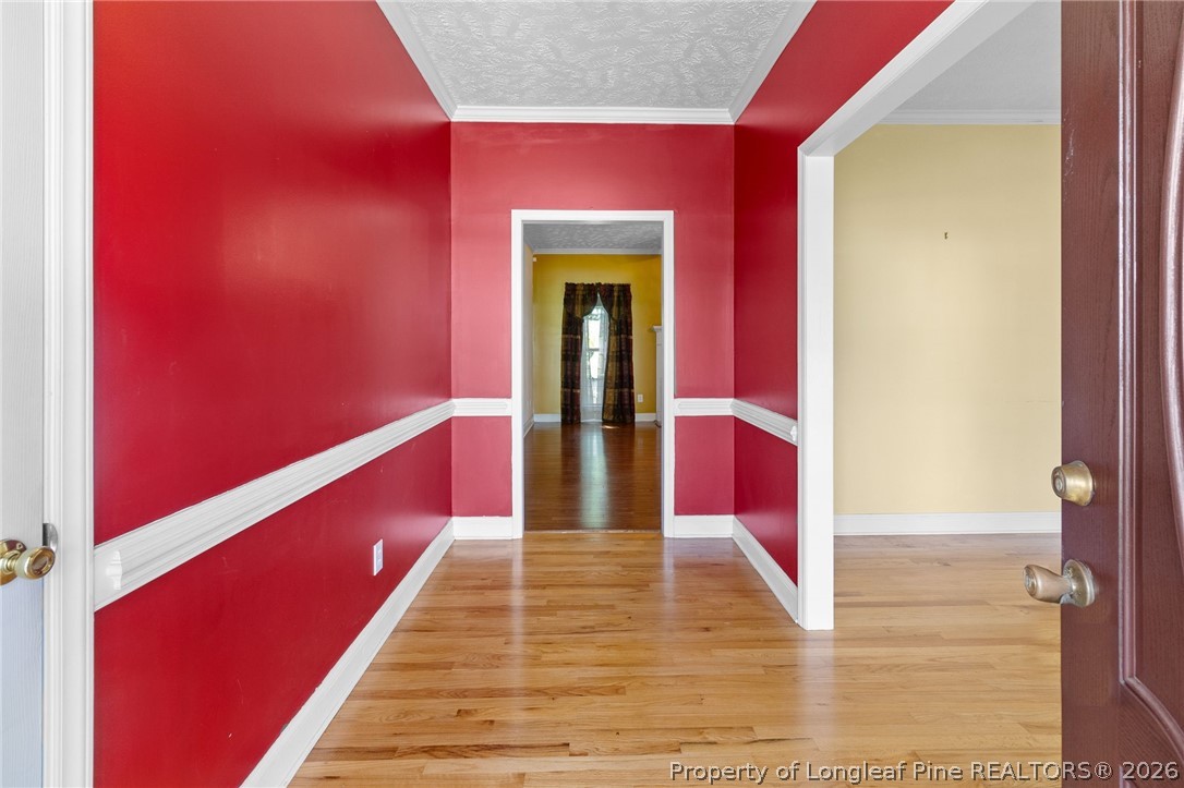 8017 Trout Creek Road Fayetteville, NC 28304 - Photo 3 of 38 a view of a hallway with wooden floor