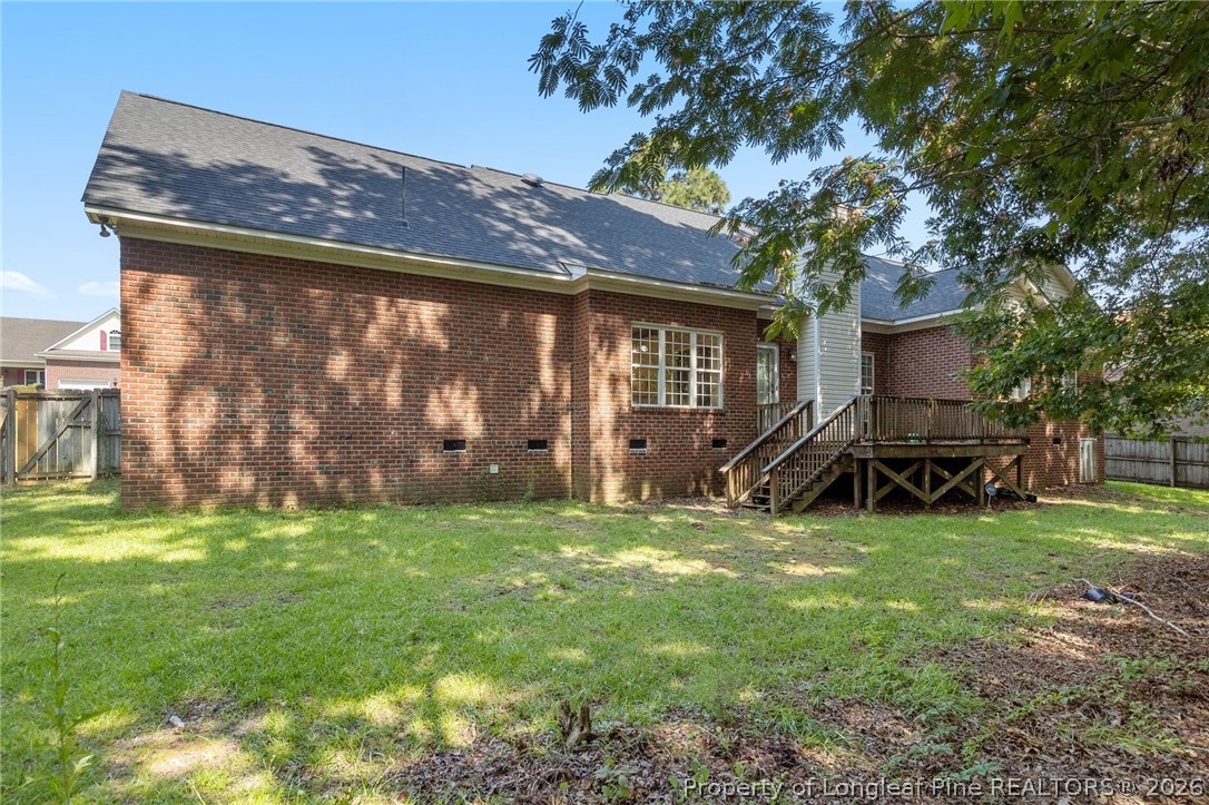 8017 Trout Creek Road Fayetteville, NC 28304 - Photo 36 of 38 a view of a backyard with plants and a large tree