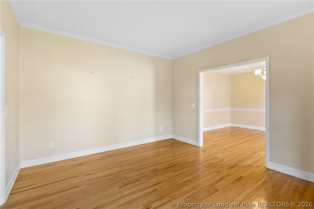 8017 Trout Creek Road Fayetteville, NC 28304 - Photo 5 of 38 a view of an empty room with wooden floor and a window