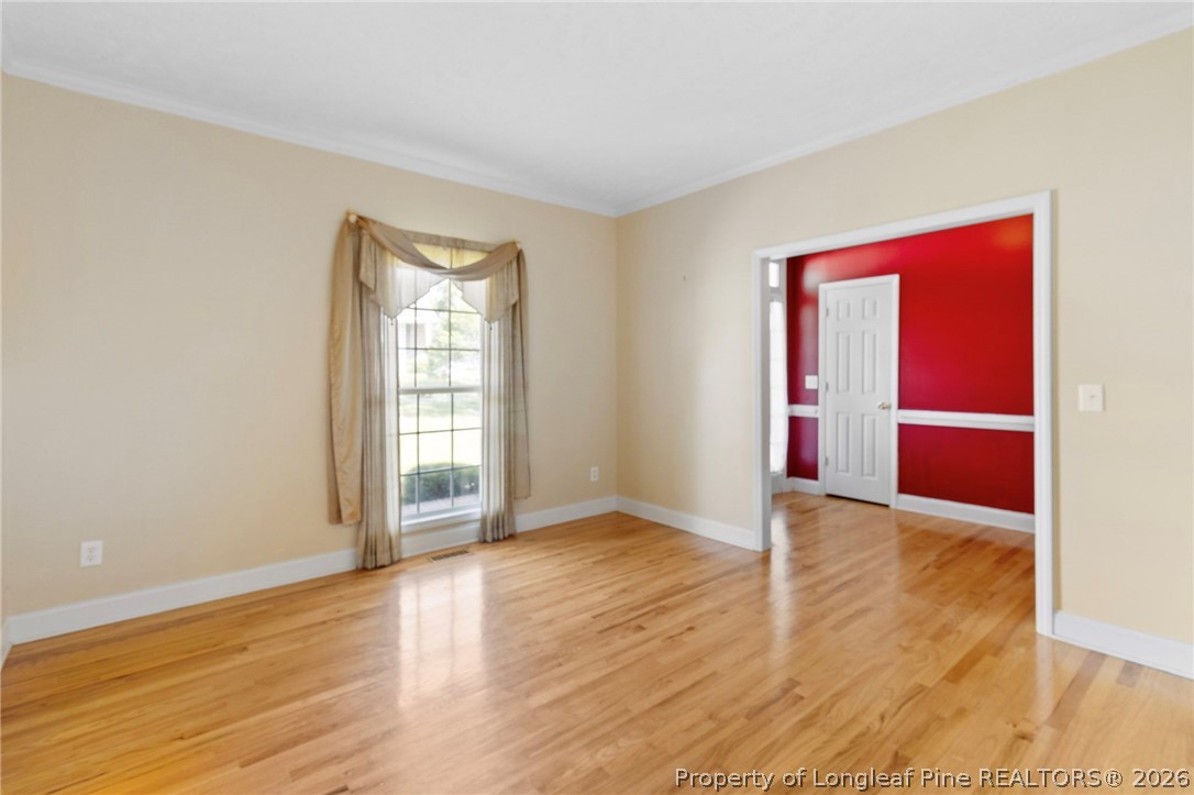 8017 Trout Creek Road Fayetteville, NC 28304 - Photo 6 of 38 an empty room with wooden floor and windows