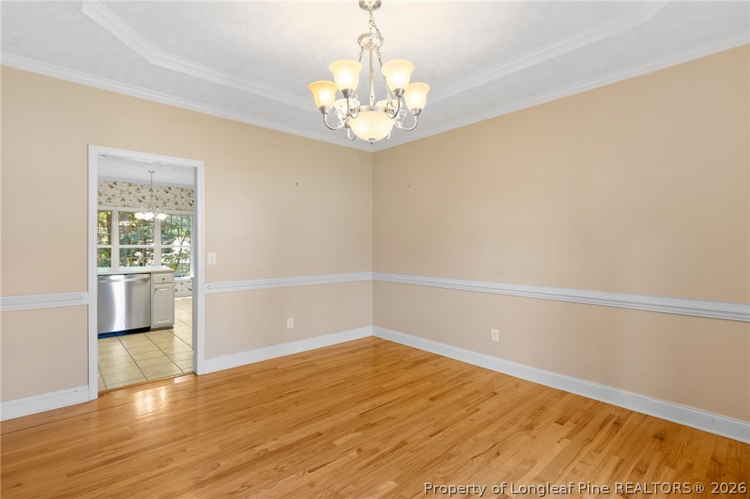 8017 Trout Creek Road Fayetteville, NC 28304 - Photo 7 of 38 a view of a room with wooden floor and chandelier
