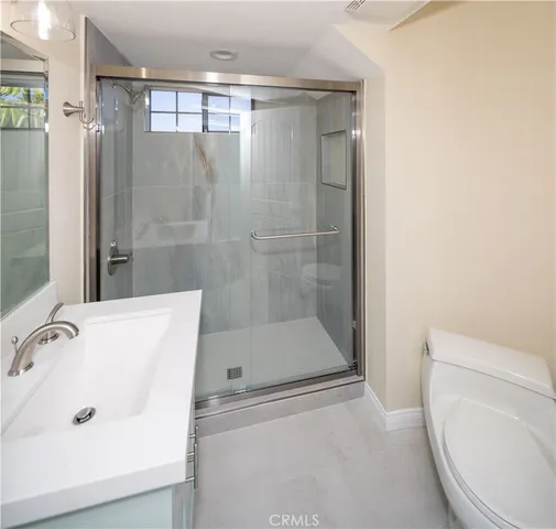 a bathroom with a shower and toilet