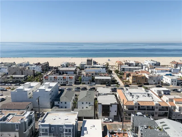 an aerial view of a building and ocean view