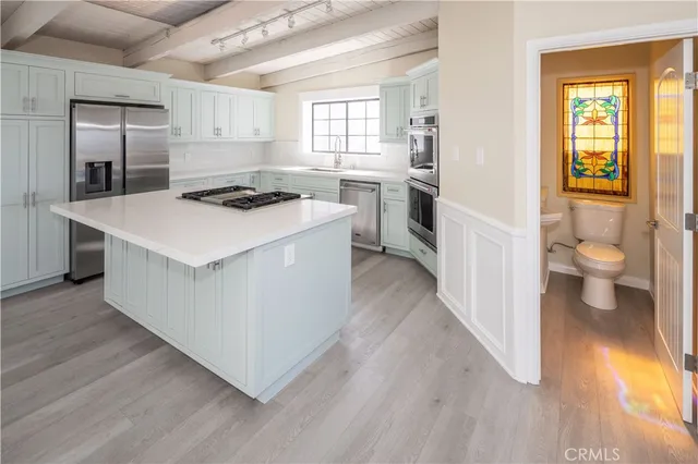 a kitchen with a stove a sink and a refrigerator