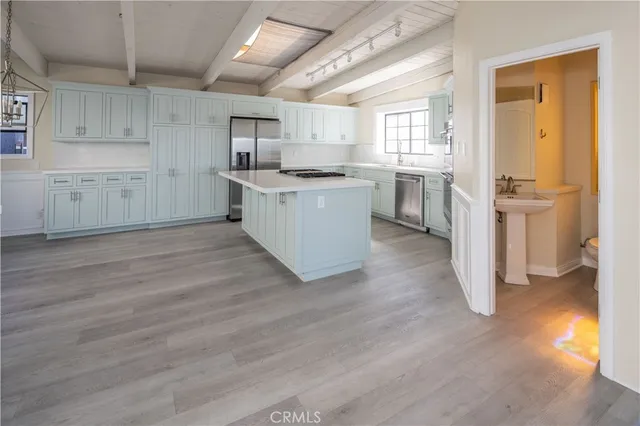 a kitchen with cabinets and wooden floor