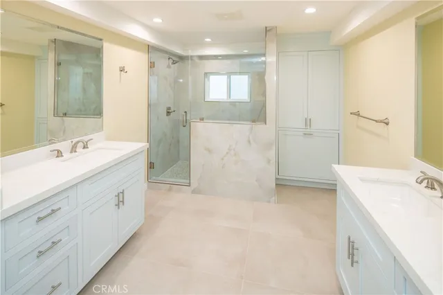 a spacious bathroom with a shower tub sink and mirror