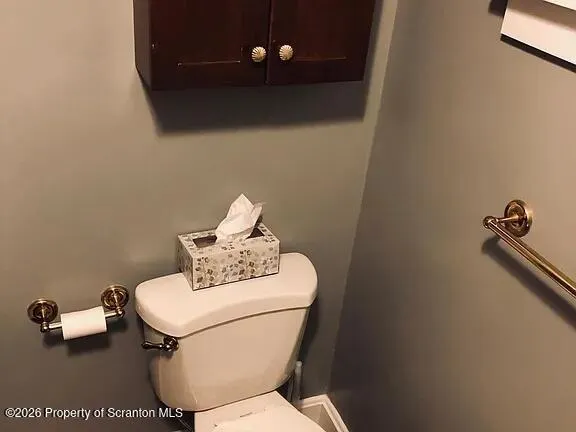 a bathroom with a sink toilet and mirror