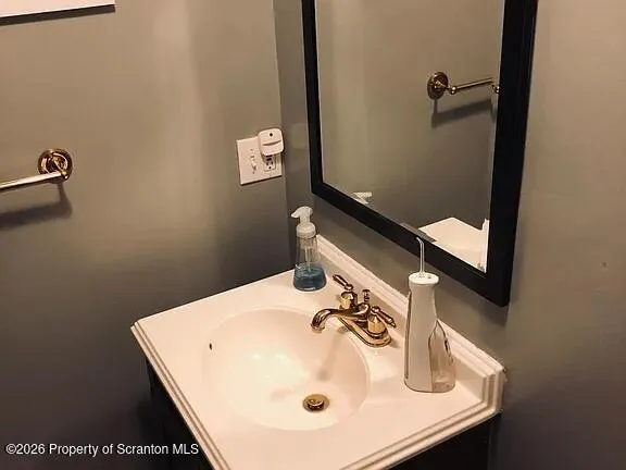a bathroom with a sink and mirror