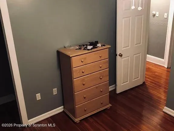 a view of a small space with wooden floor and staircase