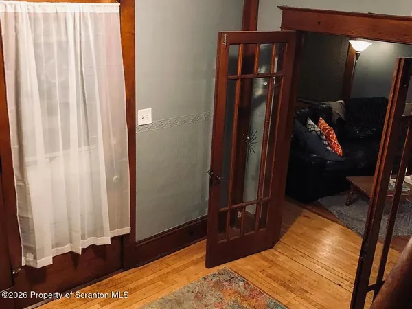 a bedroom with a bed and a lamp on dresser