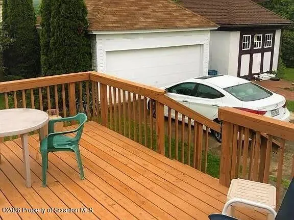 a view of balcony with wooden floor and seating space