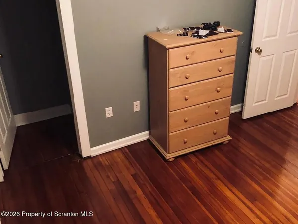 a view of a dresser with wooden floor