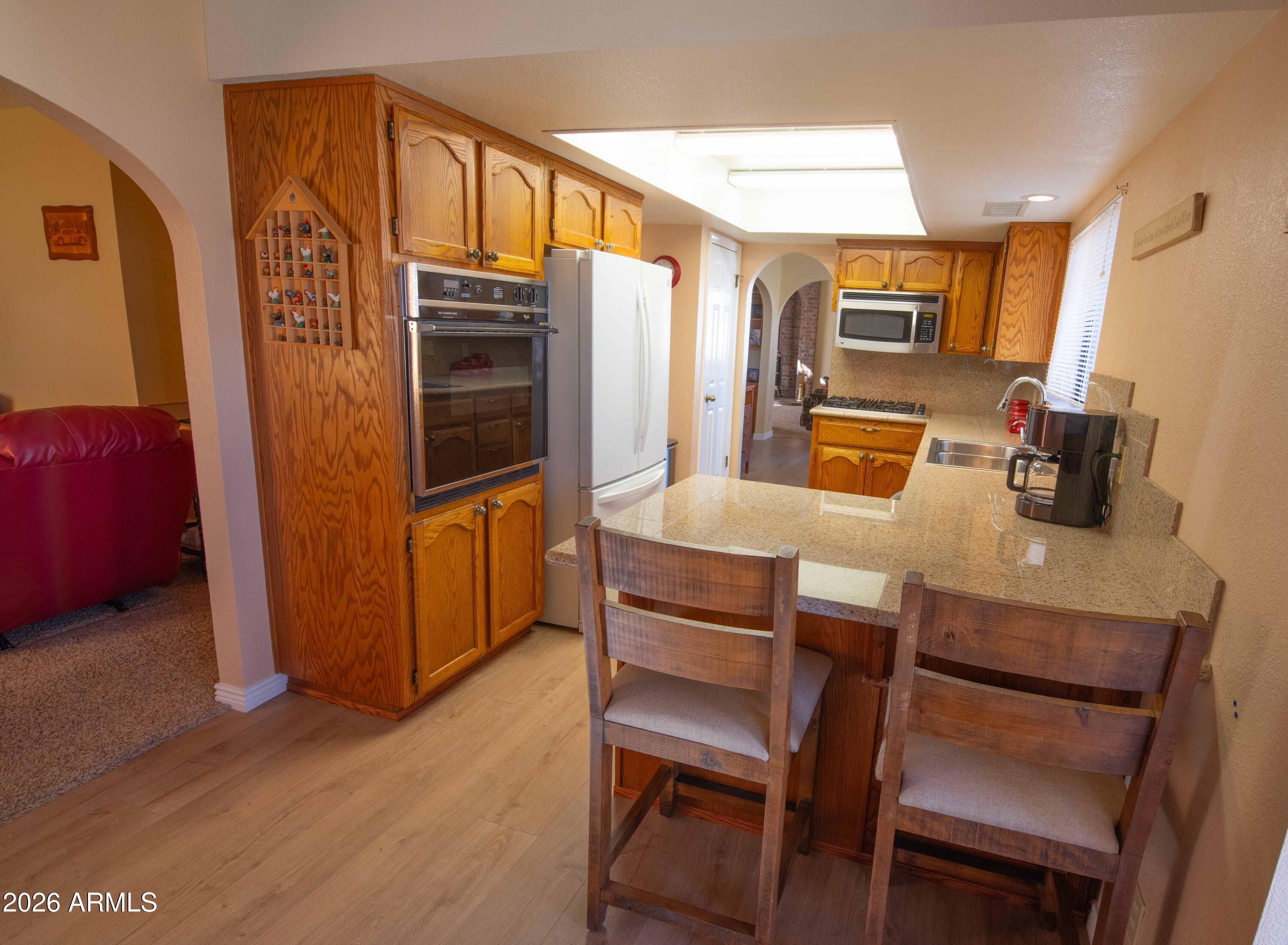 1531 Rim View Drive Page, AZ 86040 - Photo 8 of 35 a kitchen with a table chairs refrigerator and microwave