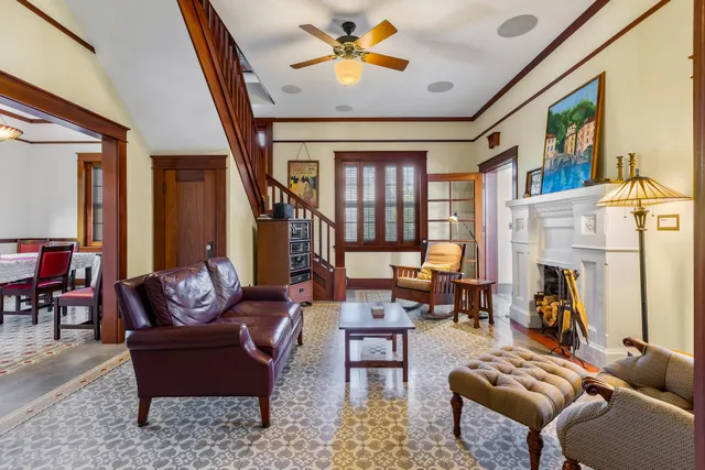 a living room with furniture a fireplace and a large window