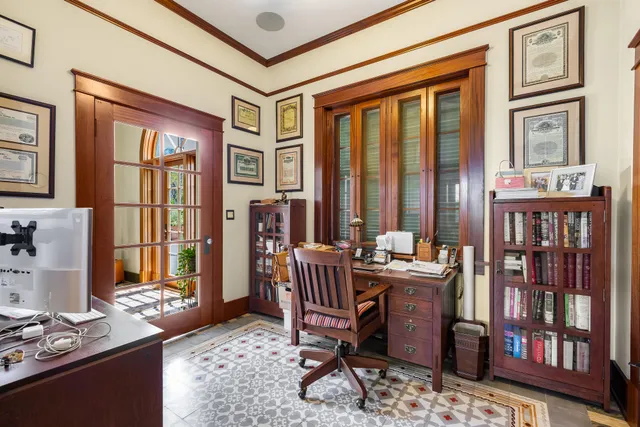a living room with furniture and large windows