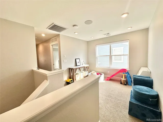 a bedroom with furniture and a large window