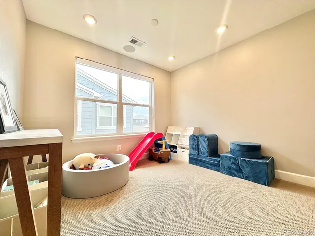 a living room with furniture and large window