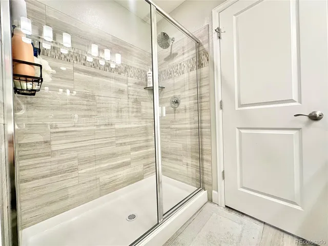 a bathroom with a glass shower door