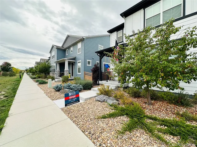 a wooden bench sitting in front of a building